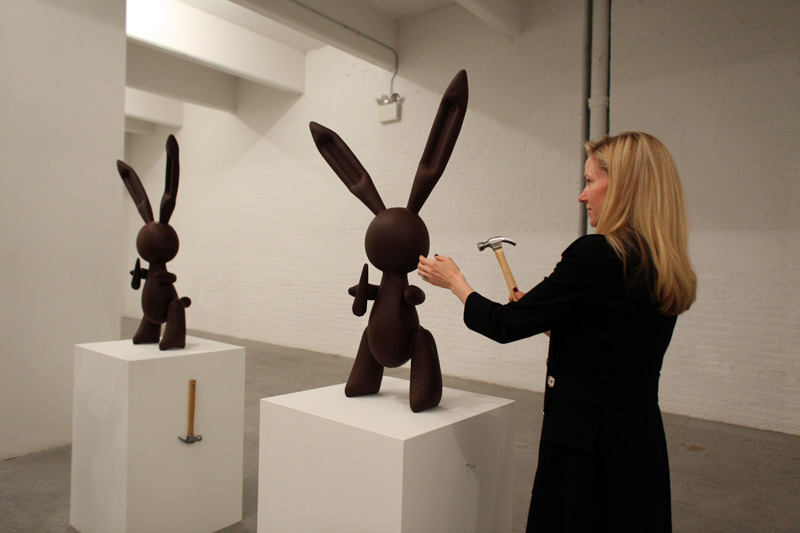 Jennifer Rubell, Creation, the Performa 09 Opening Night Benefit Dinner, 2009. Guest about to hammer a chocolate replica of Jeff Koons's Rabbit made by Jacques Torres