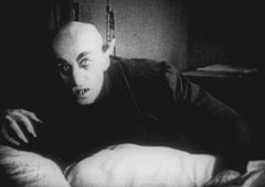 Граф Орлок (Макс Шрек) укусил Элен Хаттер (Грета Шредер). Кадр из фильма «Носферату. Симфония ужаса» (1921)